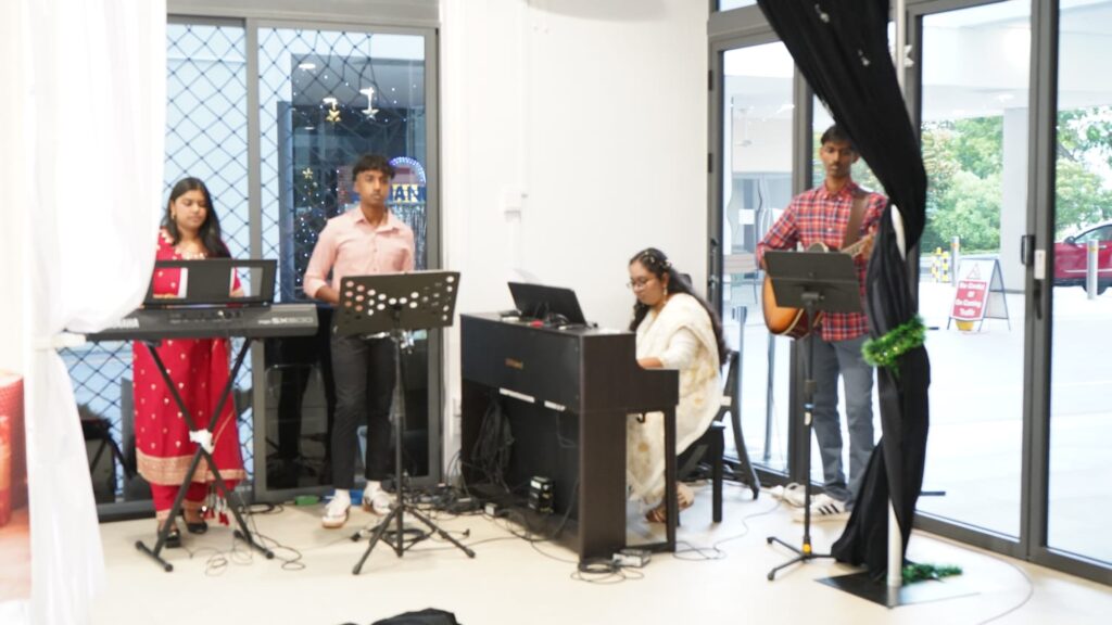 Youth ministry members leading worship with musical instruments at SJSM Tamil Church.